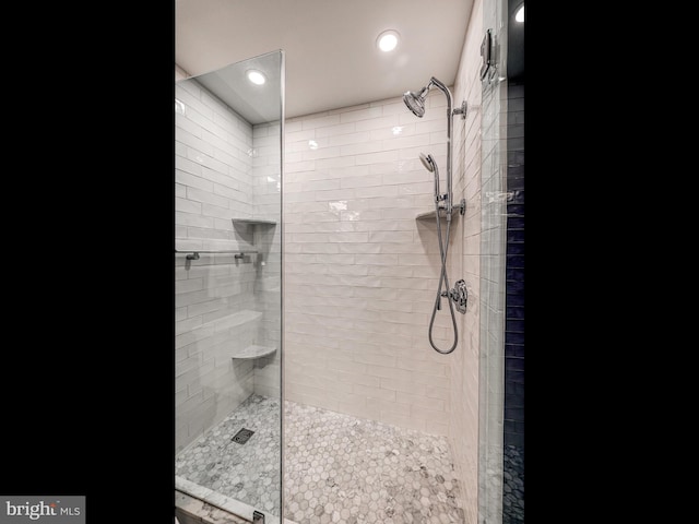 bathroom with recessed lighting and tiled shower