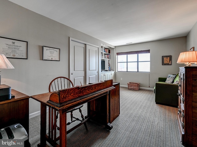 carpeted home office with baseboards