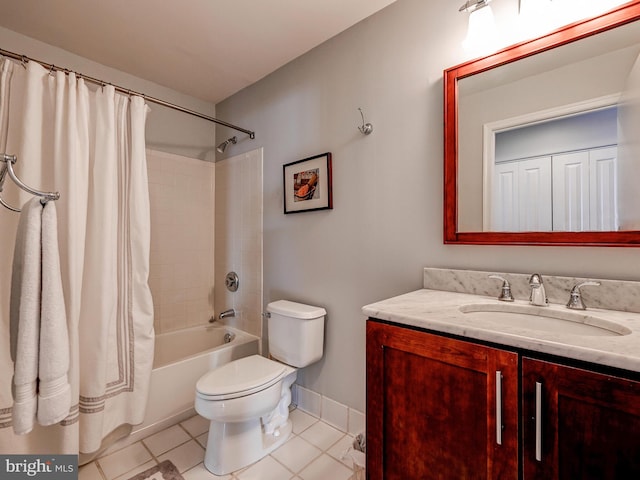 bathroom featuring vanity, baseboards, tile patterned flooring, shower / bath combo with shower curtain, and toilet