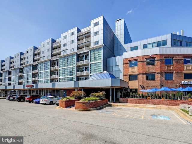 view of building exterior featuring uncovered parking