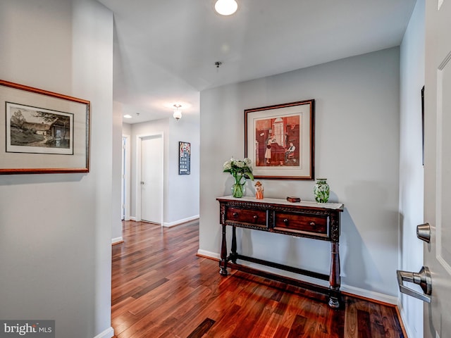 hallway with recessed lighting, wood finished floors, and baseboards