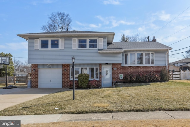 tri-level home with brick siding, a front lawn, fence, concrete driveway, and a chimney