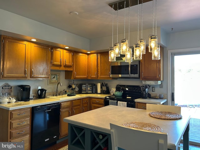 kitchen featuring brown cabinets, black appliances, a sink, light countertops, and hanging light fixtures