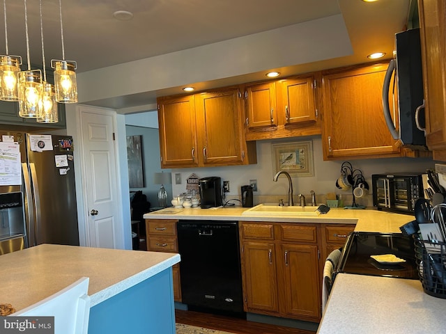 kitchen with light countertops, black dishwasher, brown cabinetry, stainless steel fridge, and a sink