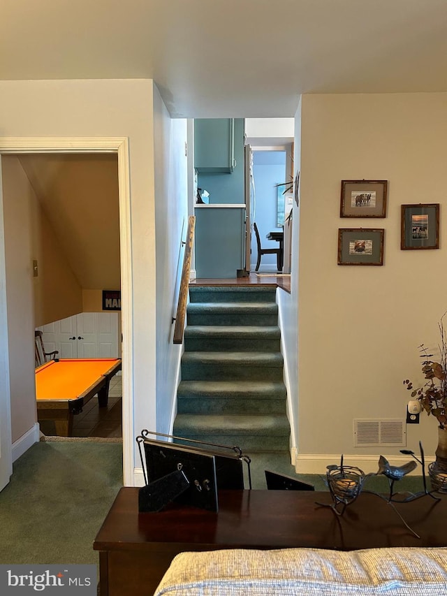 stairs with visible vents and carpet floors