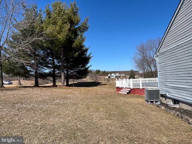 view of yard with a wooden deck and cooling unit