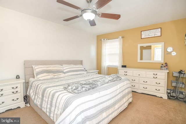 bedroom with light colored carpet and ceiling fan