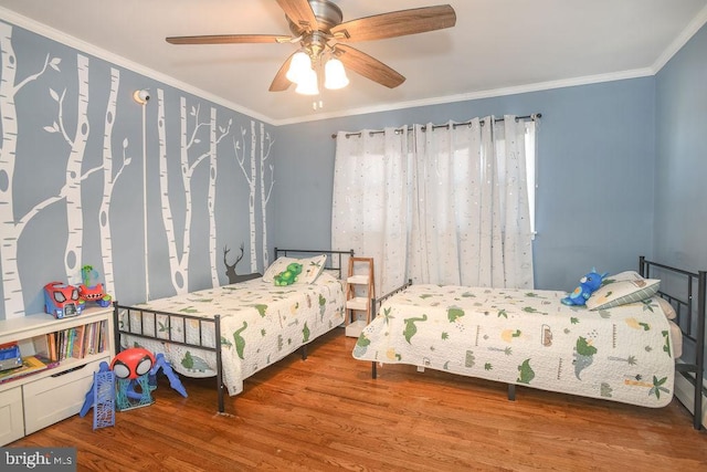 bedroom with crown molding, ceiling fan, and wood finished floors