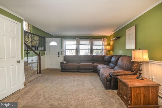 living room featuring wainscoting, stairway, carpet flooring, and ornamental molding