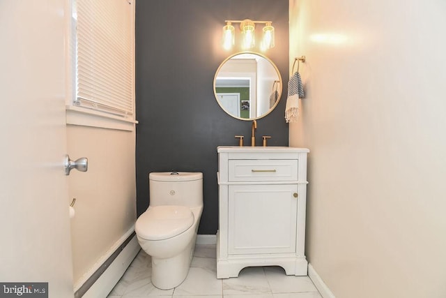 bathroom with a baseboard heating unit, baseboards, toilet, marble finish floor, and vanity