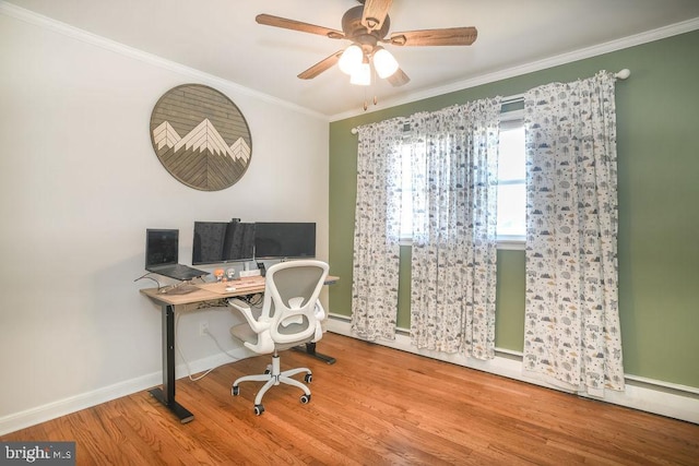 office space featuring ornamental molding, ceiling fan, baseboards, and wood finished floors