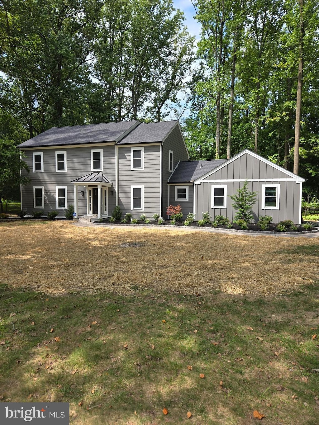 view of front of property featuring board and batten siding and a front yard