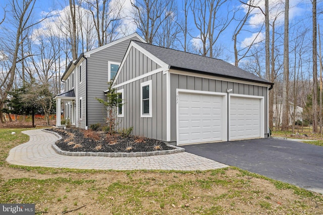 view of side of home with board and batten siding and driveway