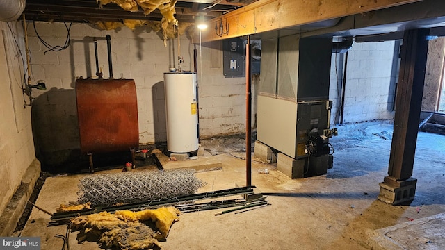 unfinished below grade area featuring heating fuel, heating unit, and water heater