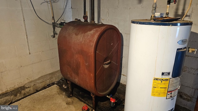 utility room with heating fuel and water heater