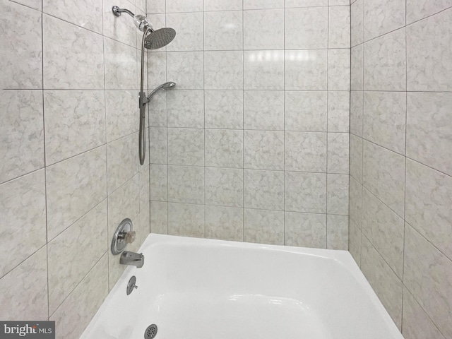 bathroom with bathing tub / shower combination