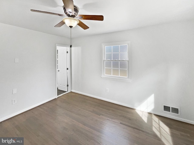 empty room with visible vents, baseboards, and wood finished floors