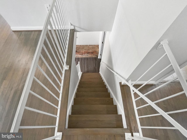 staircase with wood finished floors