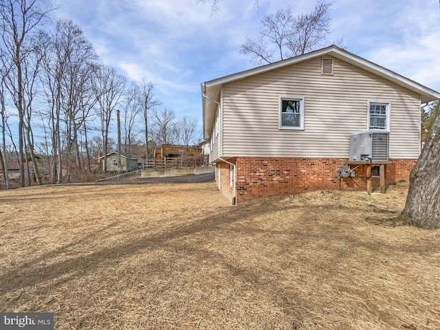 view of property exterior with brick siding