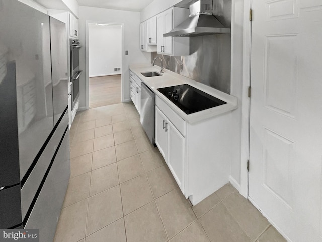 kitchen featuring a sink, stainless steel appliances, light tile patterned floors, and wall chimney range hood