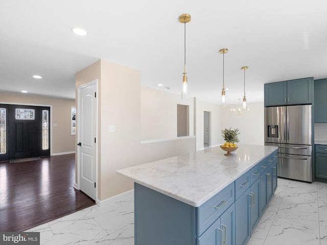 kitchen featuring light stone counters, recessed lighting, stainless steel refrigerator with ice dispenser, and marble finish floor