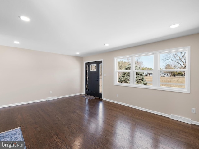 entryway with visible vents, baseboards, and dark wood-style floors