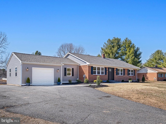 single story home featuring driveway, an attached garage, a shingled roof, a chimney, and brick siding