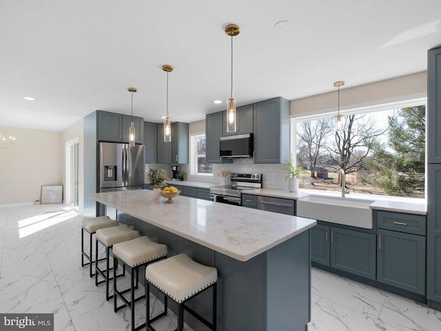 kitchen featuring a sink, stainless steel appliances, backsplash, and marble finish floor