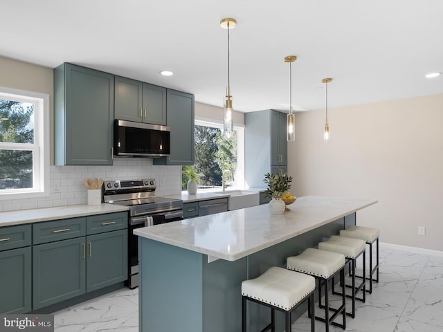 kitchen featuring a sink, stainless steel appliances, tasteful backsplash, and marble finish floor