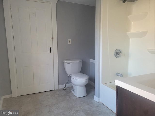 full bath featuring toilet, tub / shower combination, and baseboards