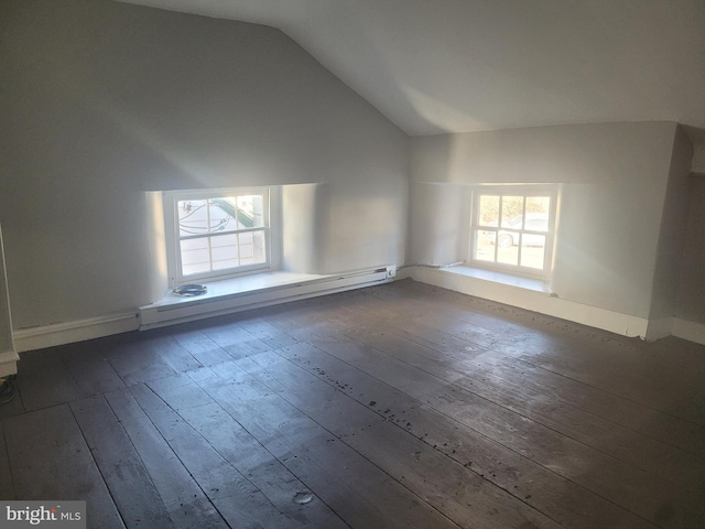 spare room featuring high vaulted ceiling, dark wood-type flooring, and a baseboard radiator