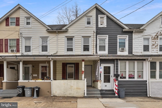 townhome / multi-family property featuring covered porch