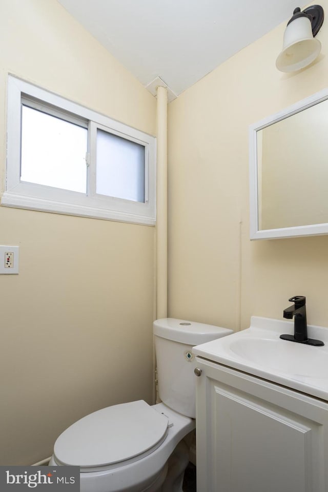 bathroom featuring toilet and vanity