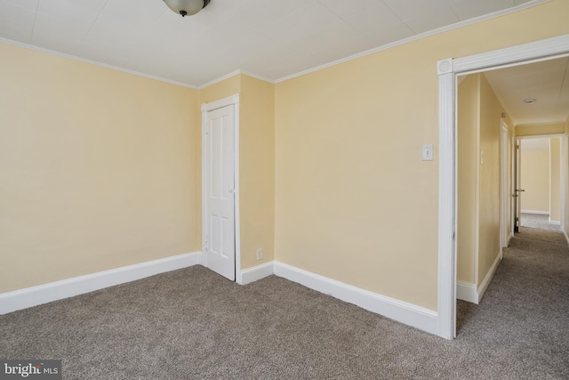 empty room with baseboards, ornamental molding, and carpet flooring