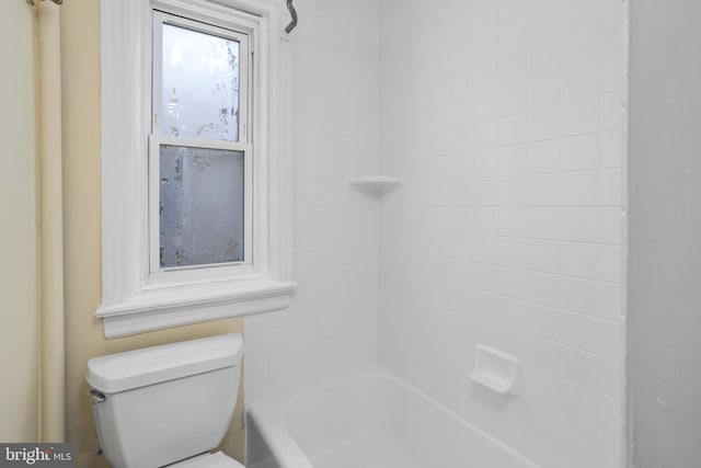 bathroom featuring toilet and shower / tub combination