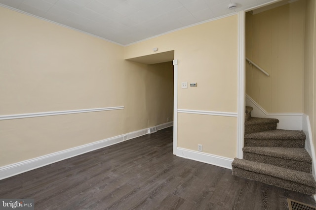 interior space with visible vents, crown molding, baseboards, and wood finished floors