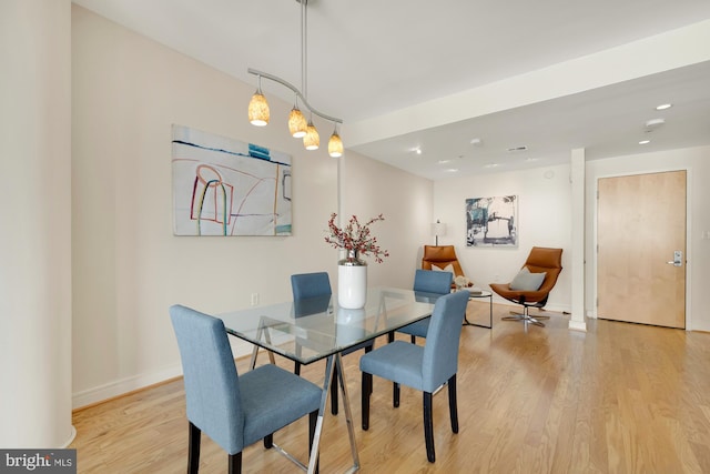 dining area featuring recessed lighting, baseboards, and light wood finished floors