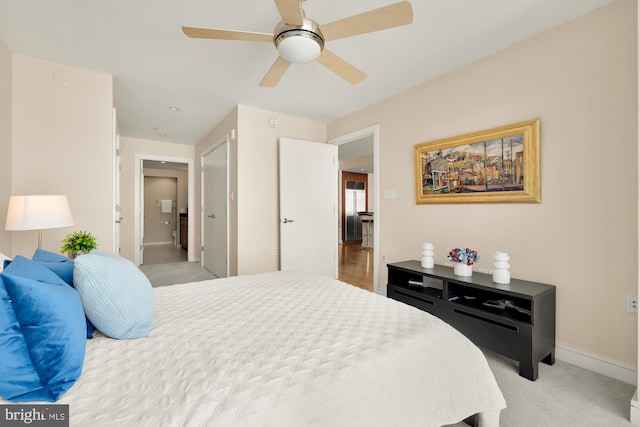 bedroom with ceiling fan, baseboards, and light carpet