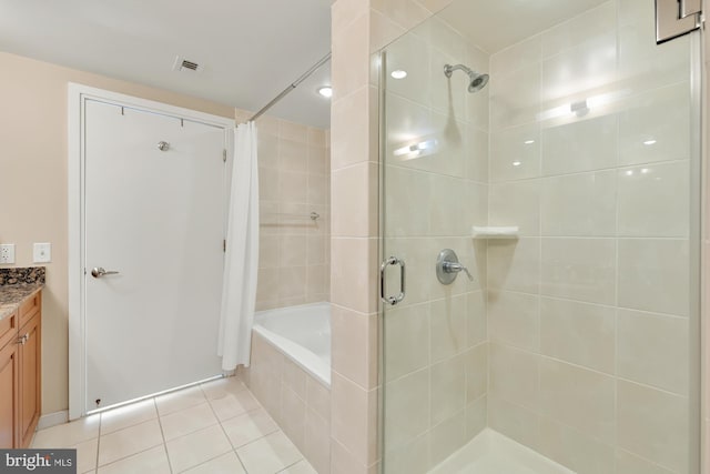 bathroom featuring visible vents, a tub to relax in, tile patterned flooring, tiled shower, and vanity