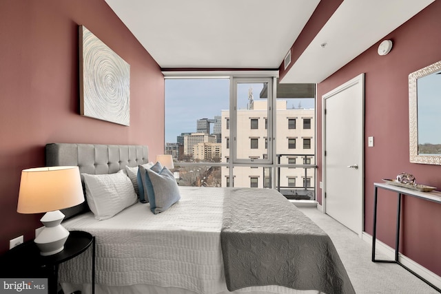 carpeted bedroom with a city view, baseboards, and visible vents