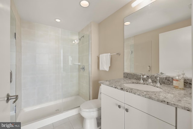 bathroom with toilet, recessed lighting, a shower stall, tile patterned flooring, and vanity