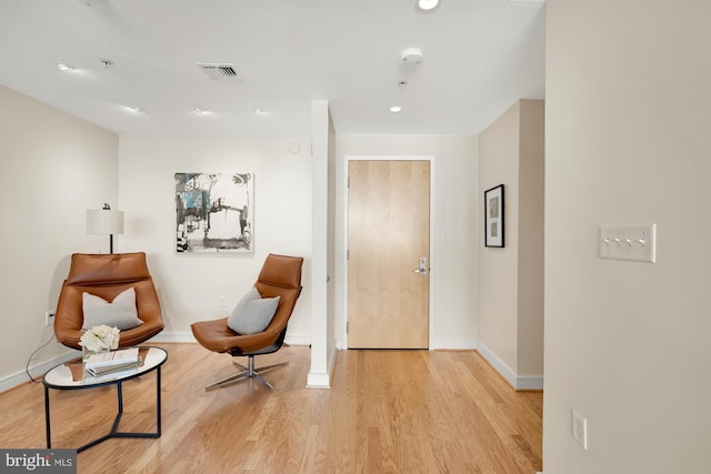 sitting room featuring recessed lighting, visible vents, baseboards, and wood finished floors