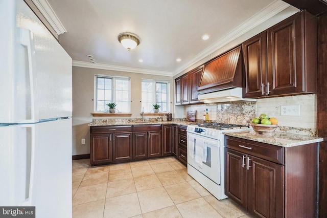 kitchen with backsplash, white appliances, crown molding, light stone countertops, and custom exhaust hood