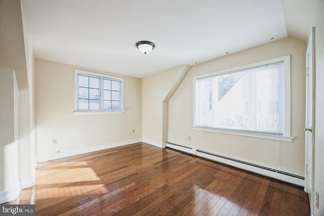 bonus room with baseboard heating, lofted ceiling, baseboards, and wood finished floors