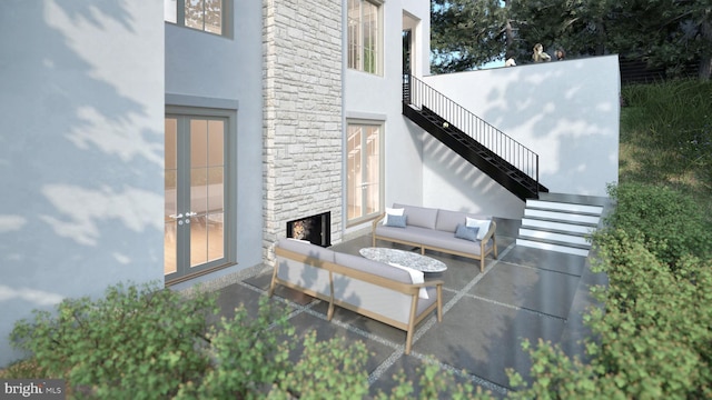 view of patio with an outdoor living space and stairway