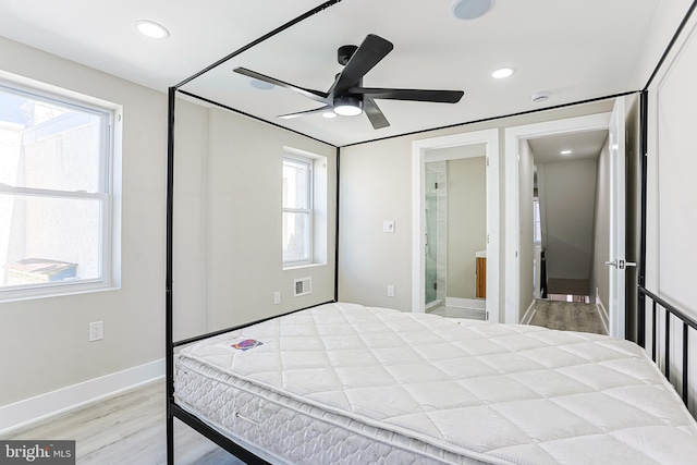 bedroom with recessed lighting, visible vents, wood finished floors, and multiple windows