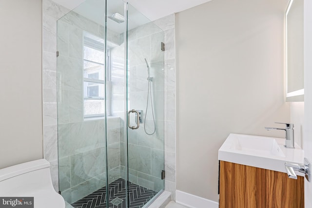 full bath with a shower stall, baseboards, toilet, and vanity