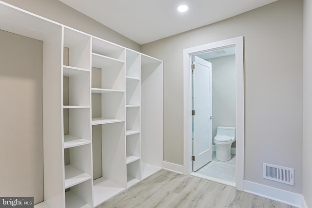 spacious closet with visible vents and wood finished floors
