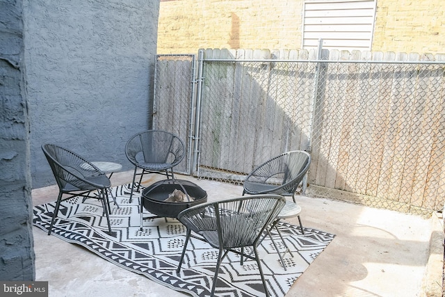view of patio featuring fence and an outdoor fire pit