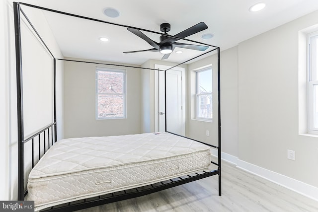 bedroom featuring baseboards, light wood-type flooring, ceiling fan, and recessed lighting